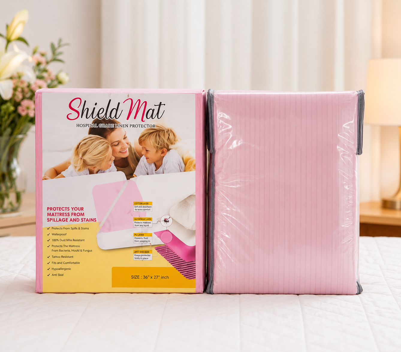 Home ShieldMat linen protector in pink packaging beside a folded pink protector